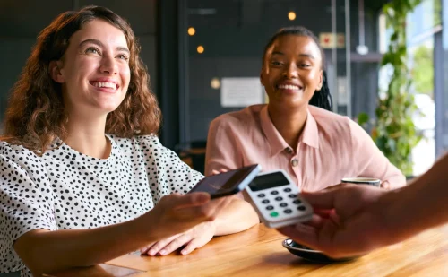 woman-in-coffee-shop-paying-bill-with-contactless-2024-10-19-16-43-22-utc (1)